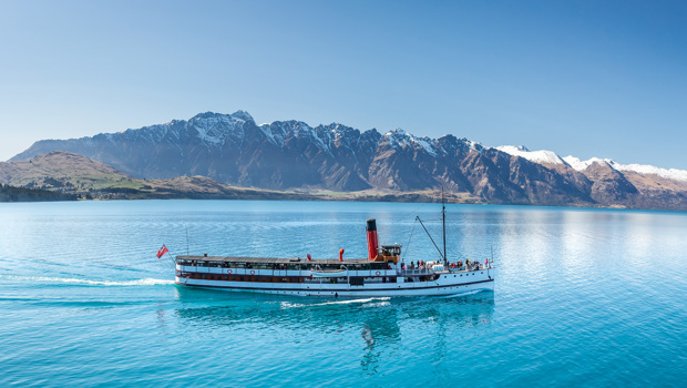 The TSS Earnslaw cruises across Lake Wakatipu with Remarkables in the background