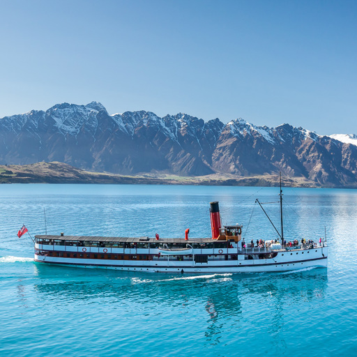 The TSS Earnslaw cruises across Lake Wakatipu with Remarkables in the background