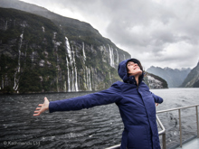 Woman enjoying the waterfalls in Fiordland National Park