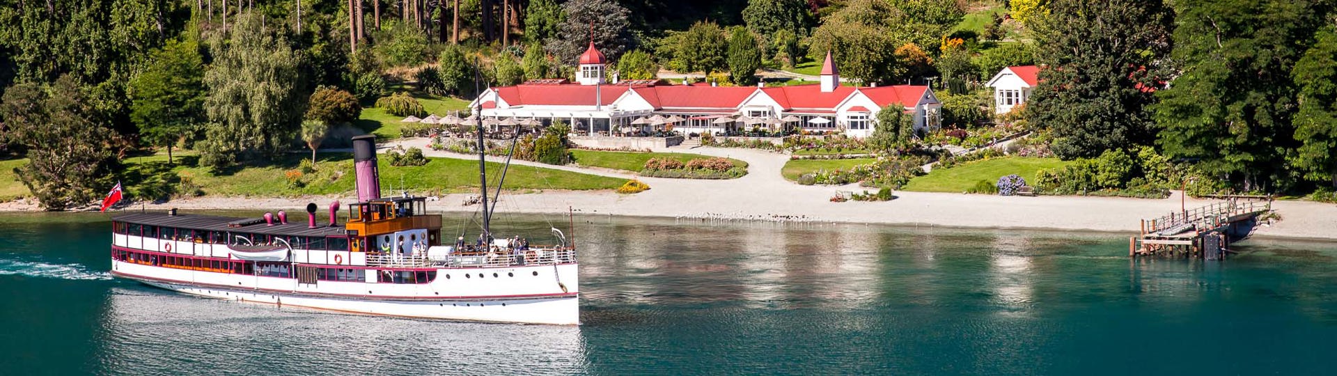 Vintage Steamship, TSS Earnslaw on Lake Wakatipu in front of the Colonel's Homestead at Walter Peak High Country Farm