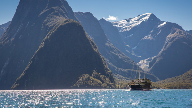 Boat, water and mountains in spectacular Milford Sound