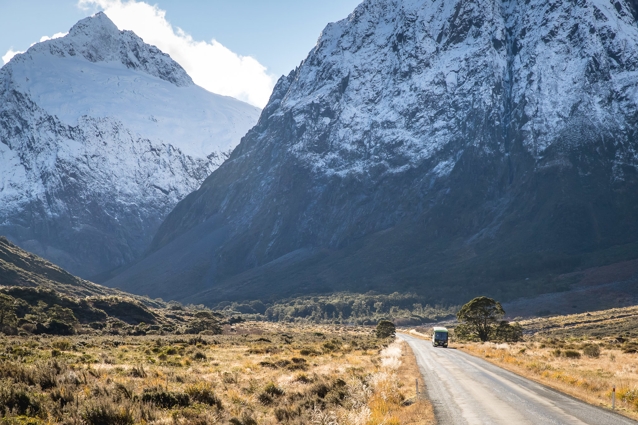 Coach driving to Milford Sound surrounded by mountains