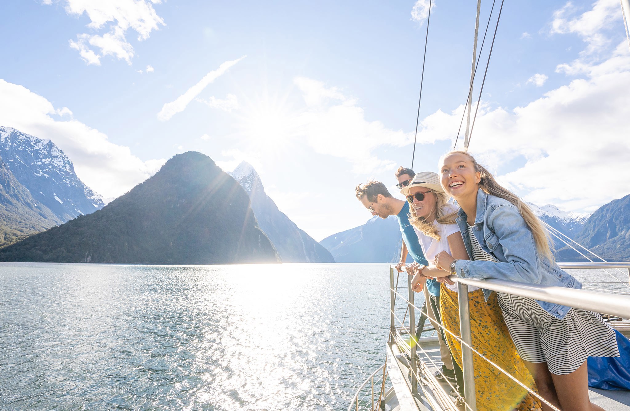 Group of friends on a cruise in Milford Sound on a sunny day