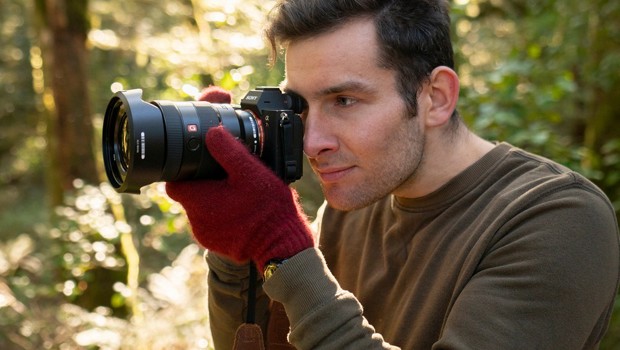 Photographer Douglas Thorne taking a photo in the forest 