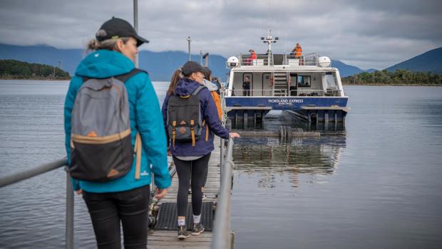 Walkers boarding the Milford Track Ferry at Te Anau Downs