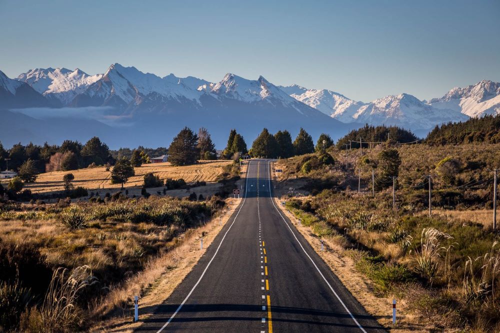 Road heading towards mountains of Milford Sound