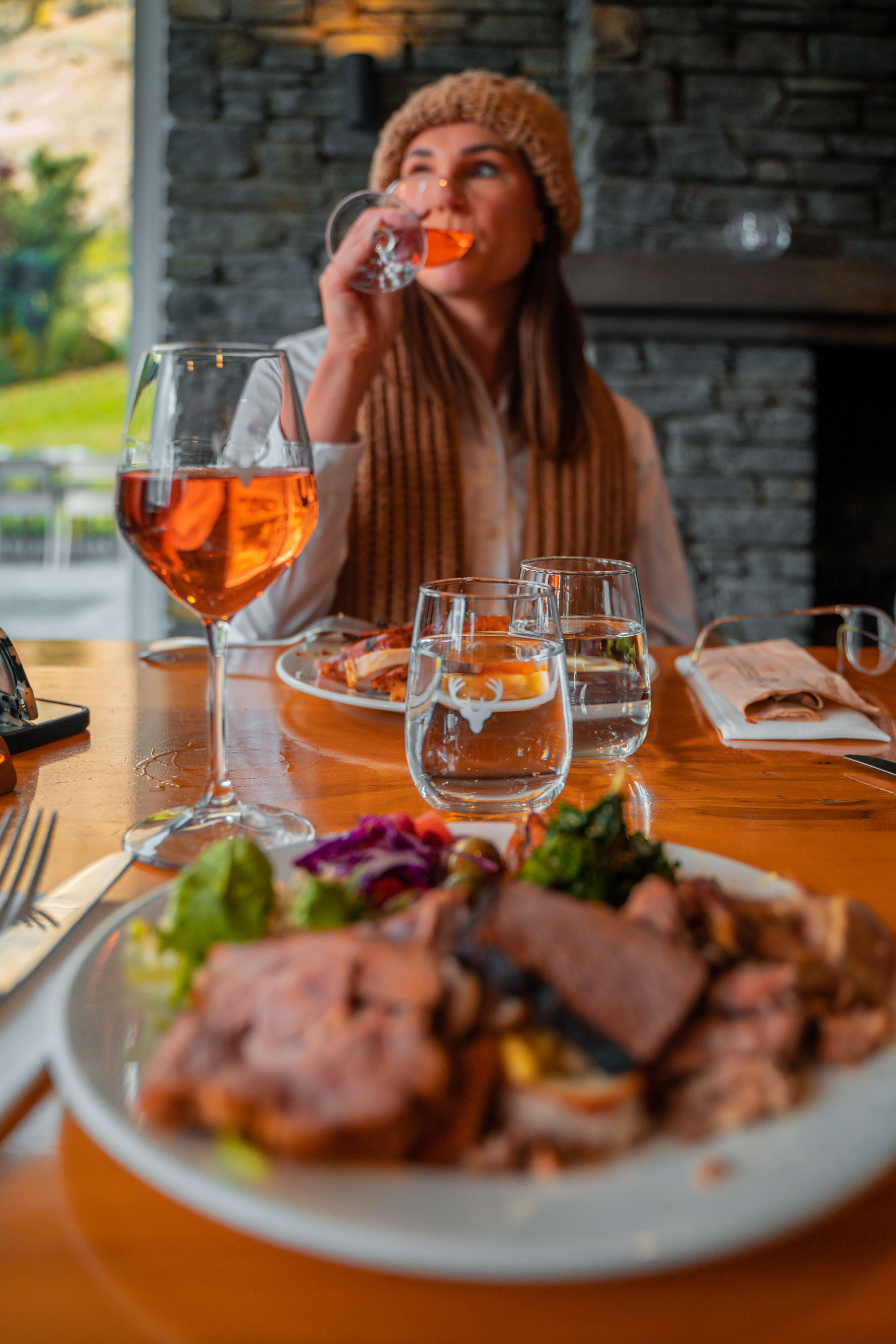 A woman sipping wine at BBQ