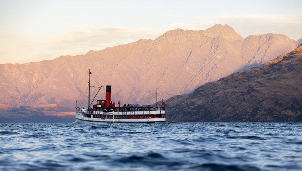 The TSS Earnslaw sailing in front of the Remarkables