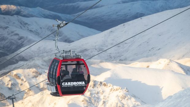 Gondola heading up a snowy mountain