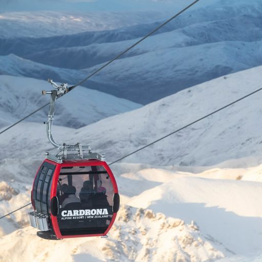 Gondola heading up a snowy mountain