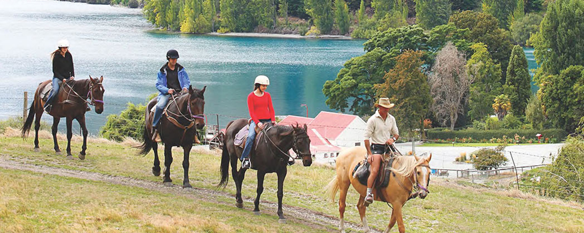 A group of horse riders ride through Walter Peak