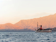 The Tss Earnslaw sails in front of the Remarkables