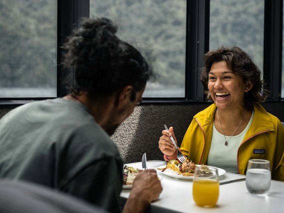 A couple enjoy a sit down lunch onboard their Milford Sound cruise 