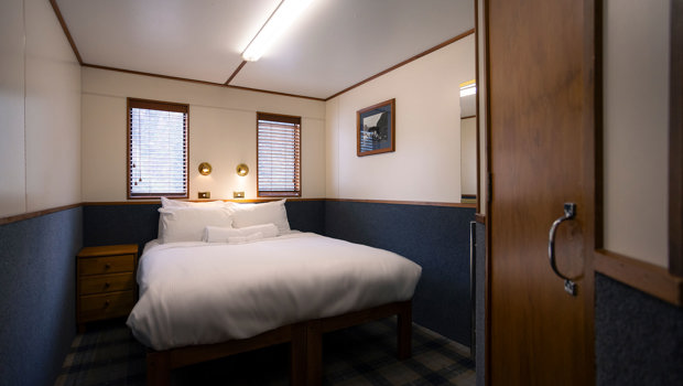 A wide shot of a bedroom onboard the Milford Wanderer overnight vessel