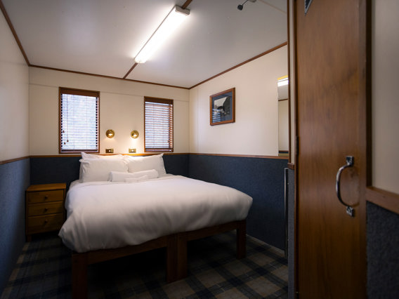 A wide shot of a bedroom onboard the Milford Wanderer overnight vessel