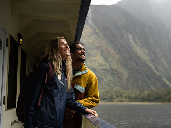 A couple enjoy the views looking over the side of the Milford Wanderer overnight vessel