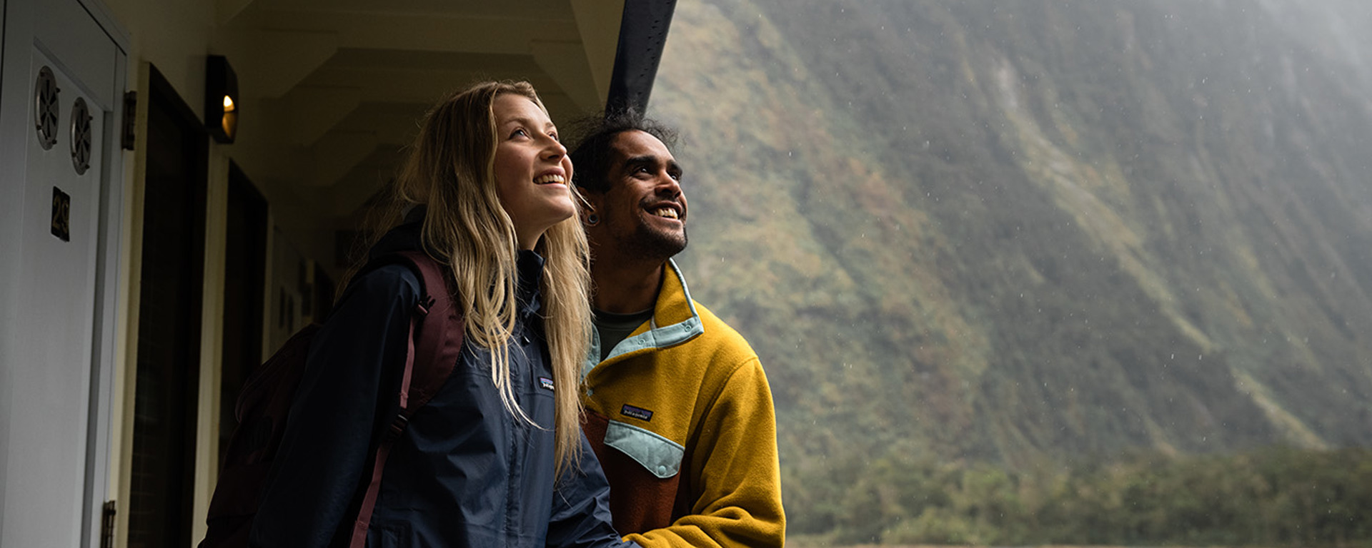 A couple enjoy the views looking over the side of the Milford Wanderer overnight vessel