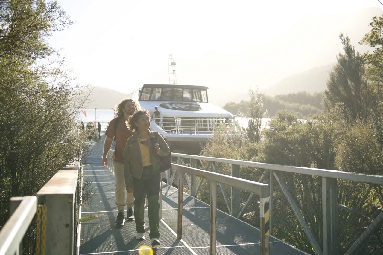 A couple disembark a RealNZ vessel