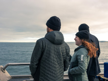 A group enjoys the view of the ocean from the Stewart Island Ferry