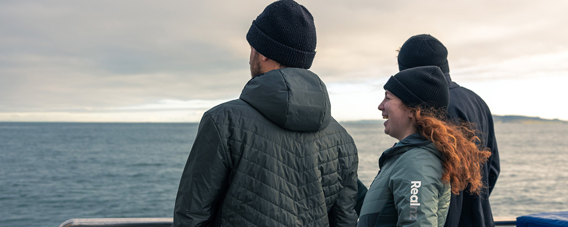 A group enjoys the view of the ocean from the Stewart Island Ferry