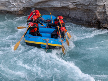 A group of rafters navigating white waters on the Shotover River