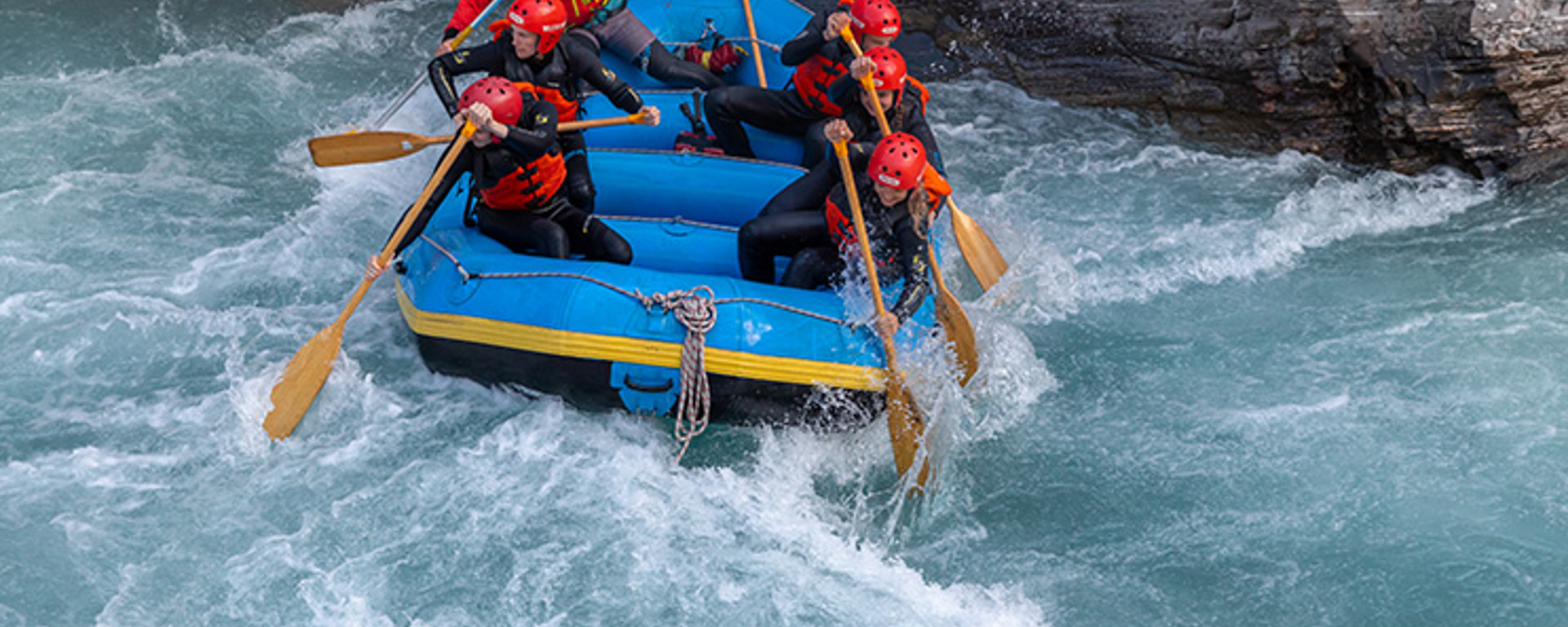 A group of rafters navigating white waters on the Shotover River