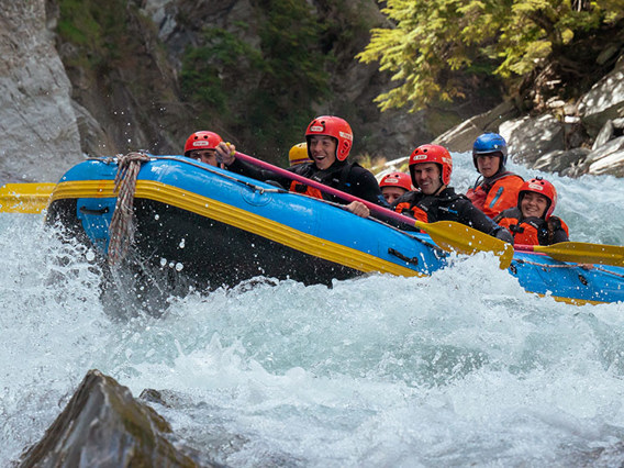 A rafting group look excitedly down at the the rapid they are about to take on the Shotover River