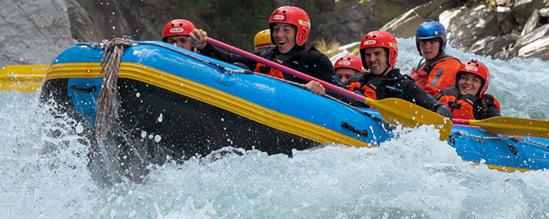 A rafting group look excitedly down at the the rapid they are about to take on the Shotover River