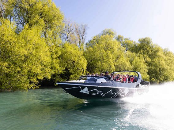 The queenstown jetboat zooming down a river