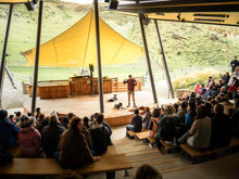 A guide demonstrates a farm show at Walter Peak High Country Farm