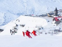 A trio of ski instructors skis down the piste at Cardrona Alpine resort