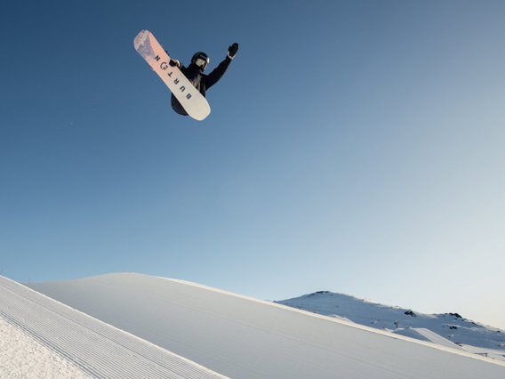 A snowboarder gets some height of the halfpipe at the Cardrona park