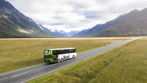 A Real NZ coach driving towards Milford Sound