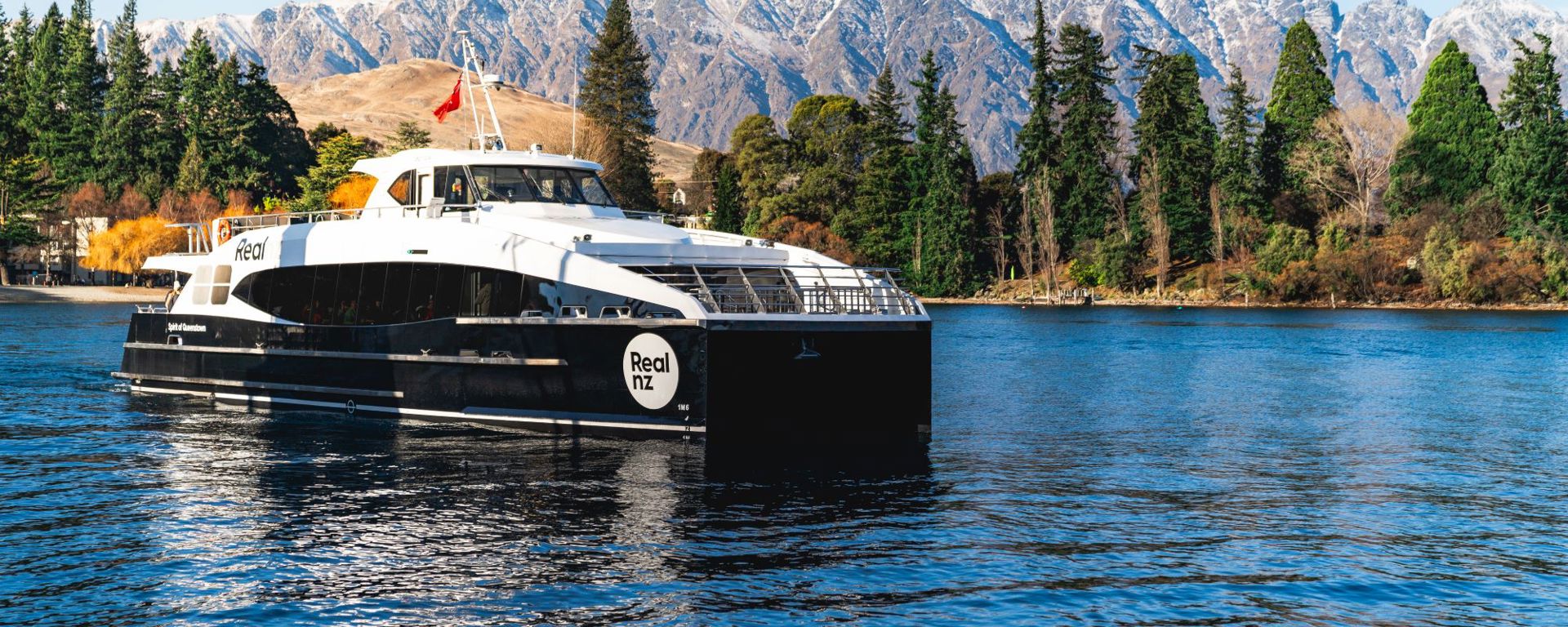 Spirit of Queenstown on the water in front of the remarkables