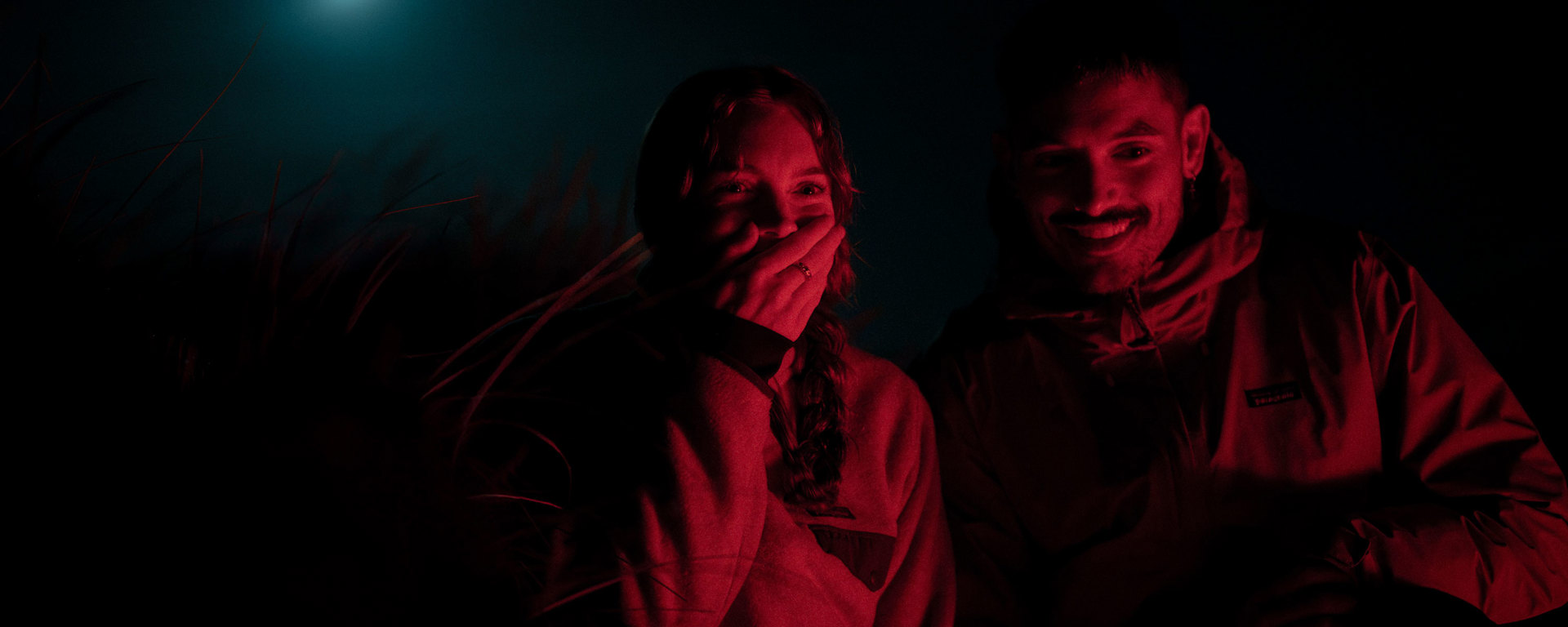 Couple searching for kiwi under a full moon