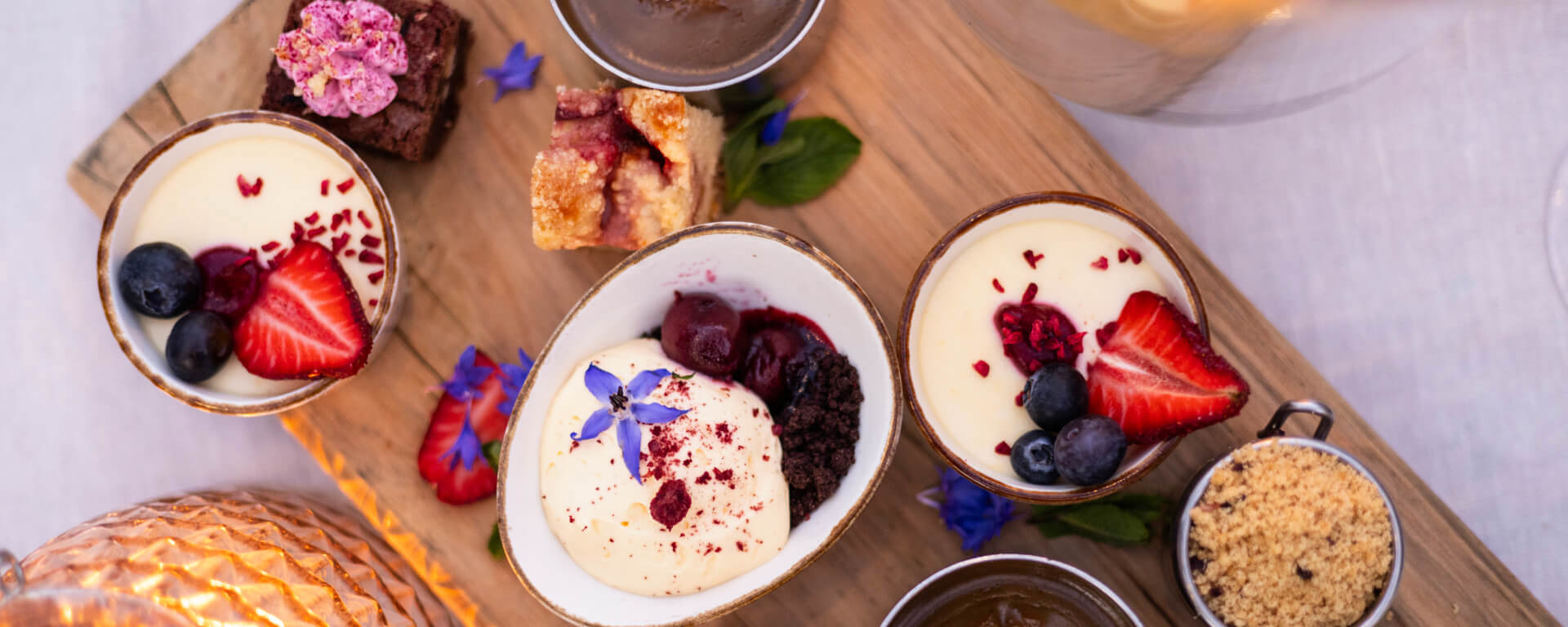 A spread of colourful desserts on a wooden board at Walter Peak in Queenstown.