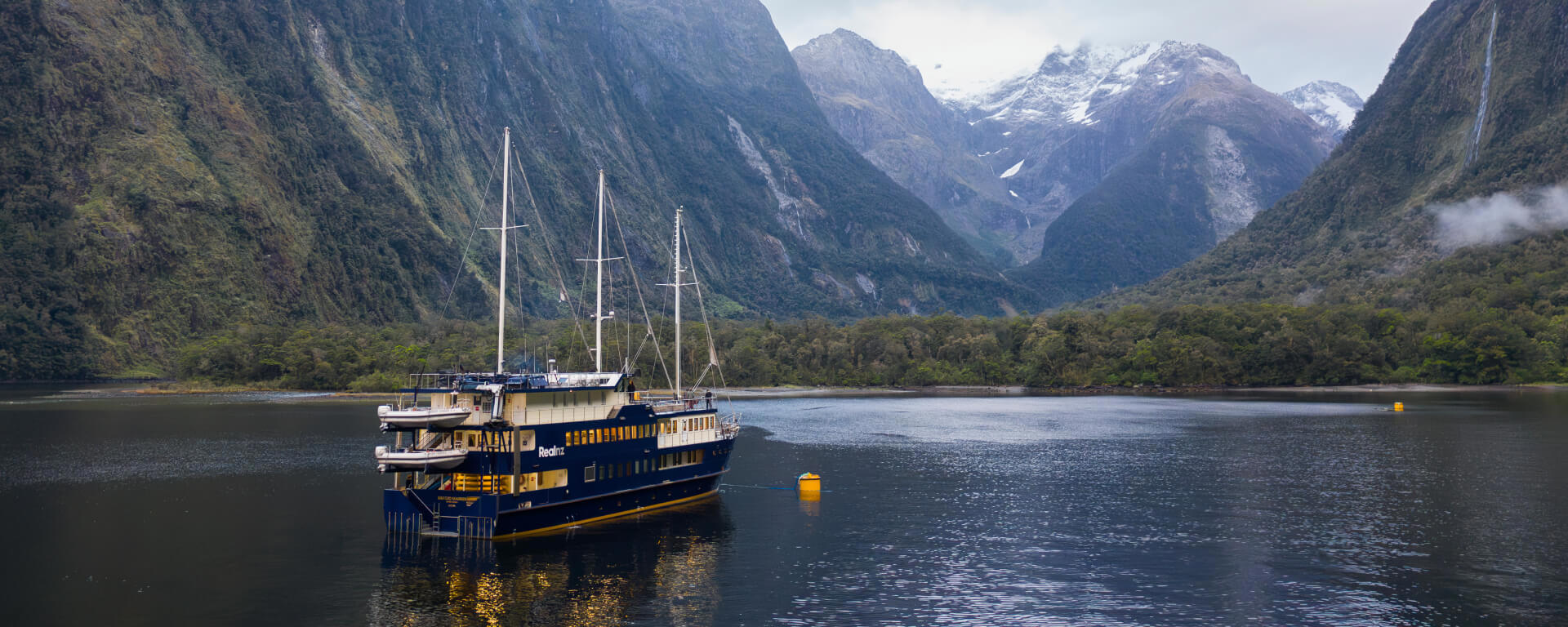 Experience Milford Sound in style aboard the Mariner—your home for an unforgettable overnight adventure surrounded by towering peaks and tranquil waters.