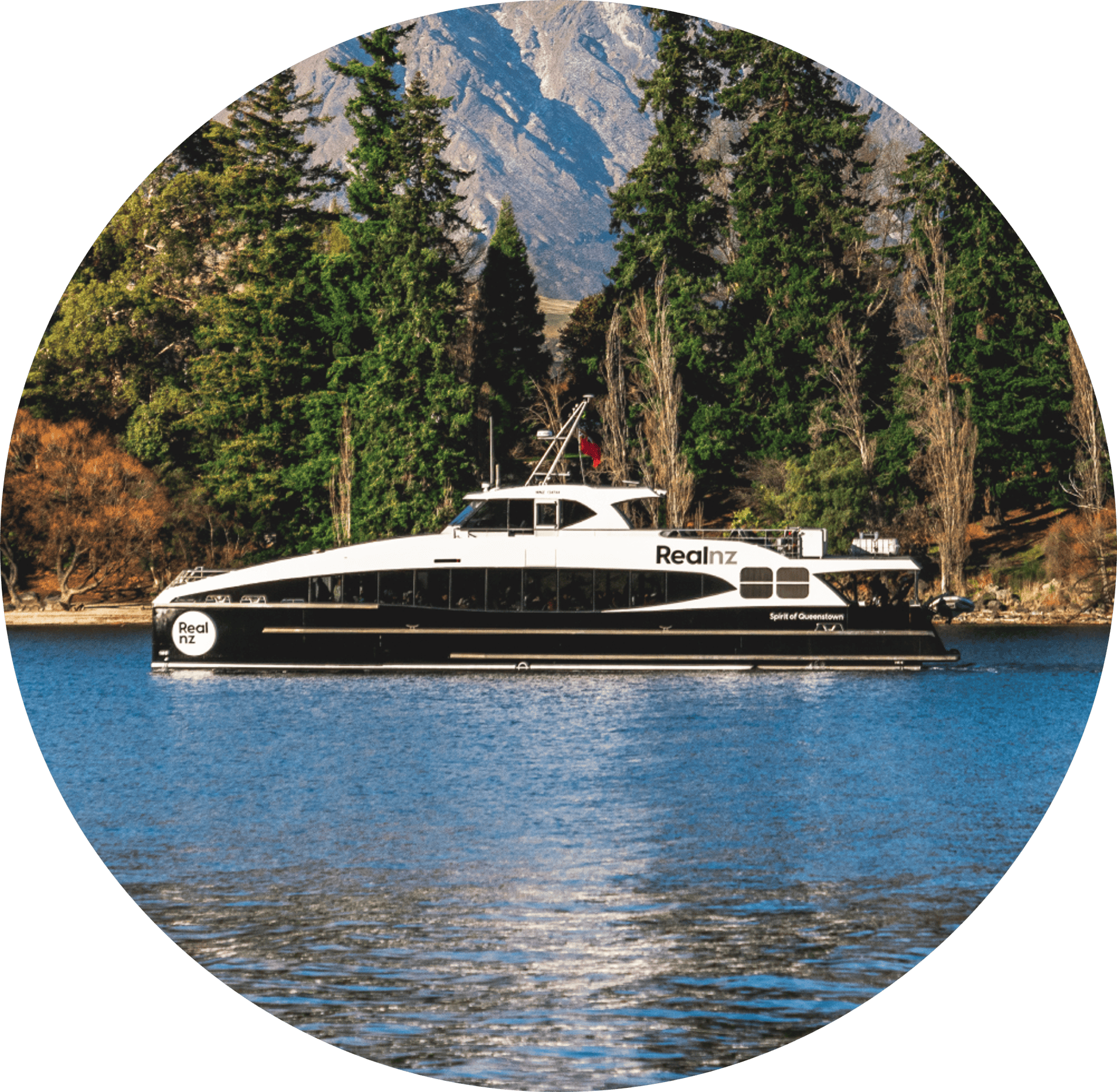 The Spirit of Queenstown boat, approaches the wharf in Queenstown bay on a sunny day.