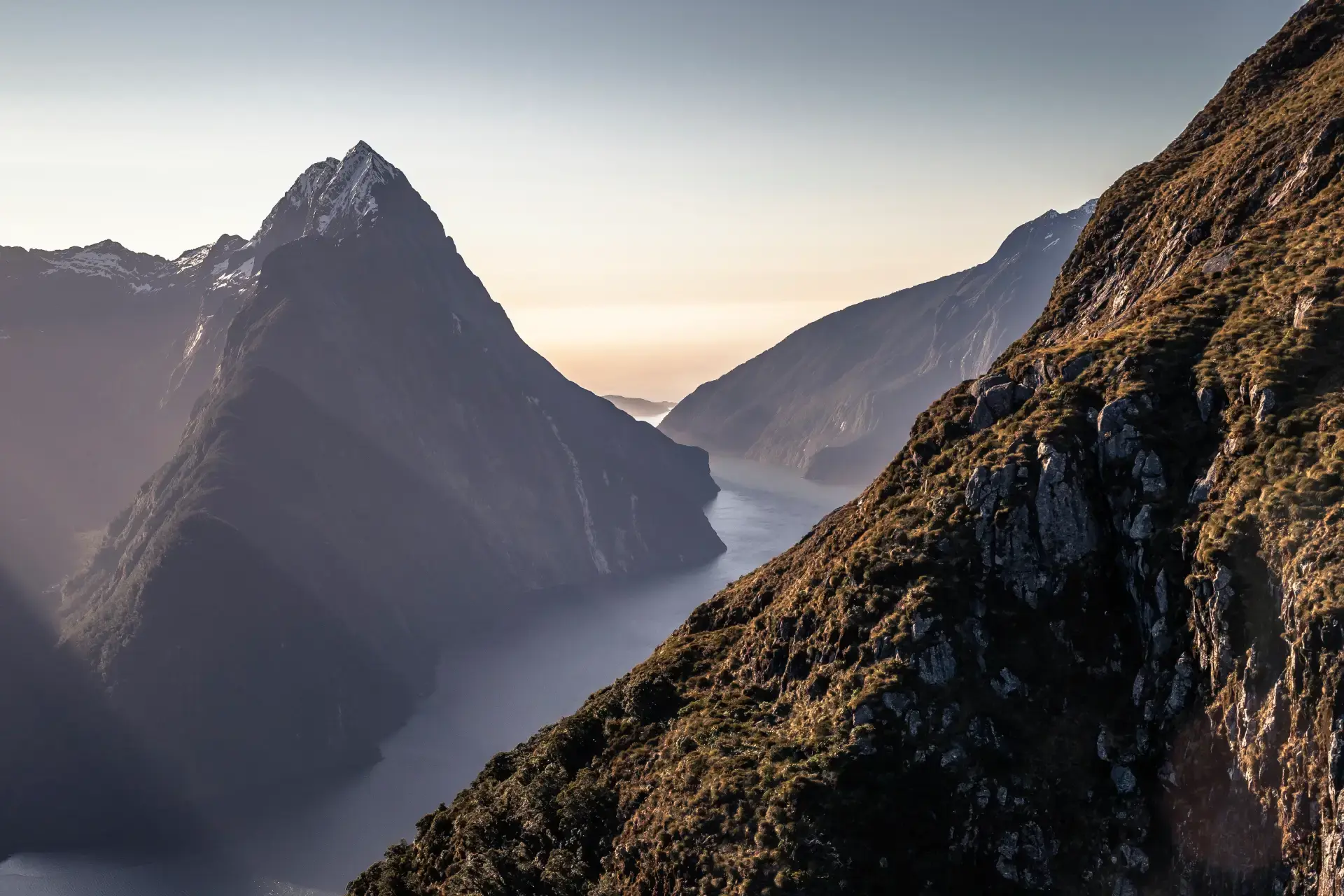 A scenic view of Milford Sound from above as the sun sets.